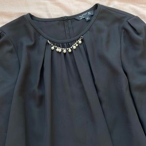 Black blouse with decorative necklace